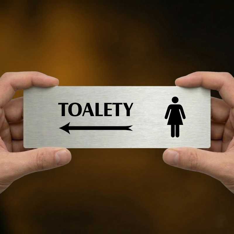 Toalety vlevo ženy, 200x66mm, zlatá popiska s dvojtým rámečkem