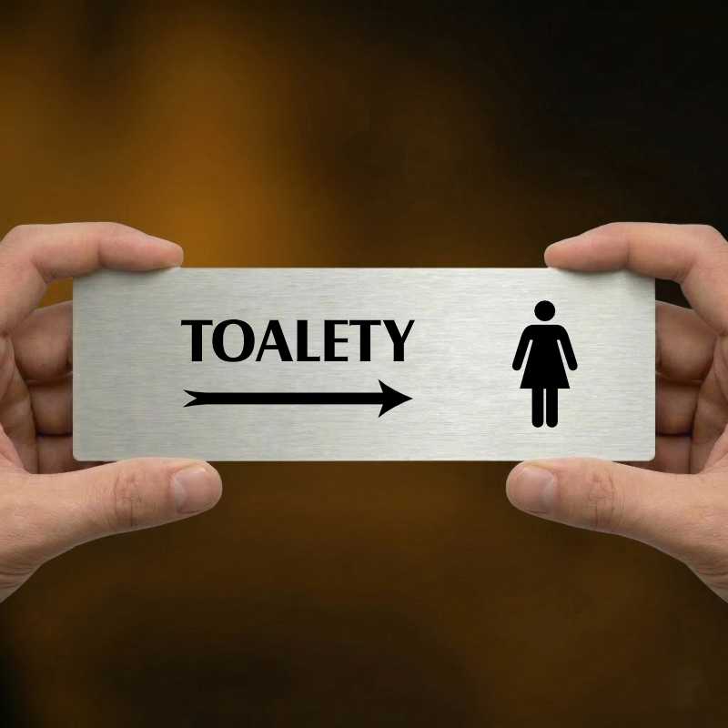 Toalety vpravo ženy, 240x79mm, stříbrná popiska 