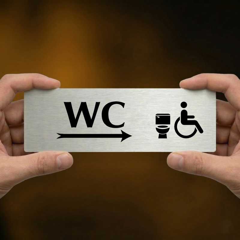 WC invalida vpravo, 240x79mm, stříbrná popiska s ozdobou uprostřed