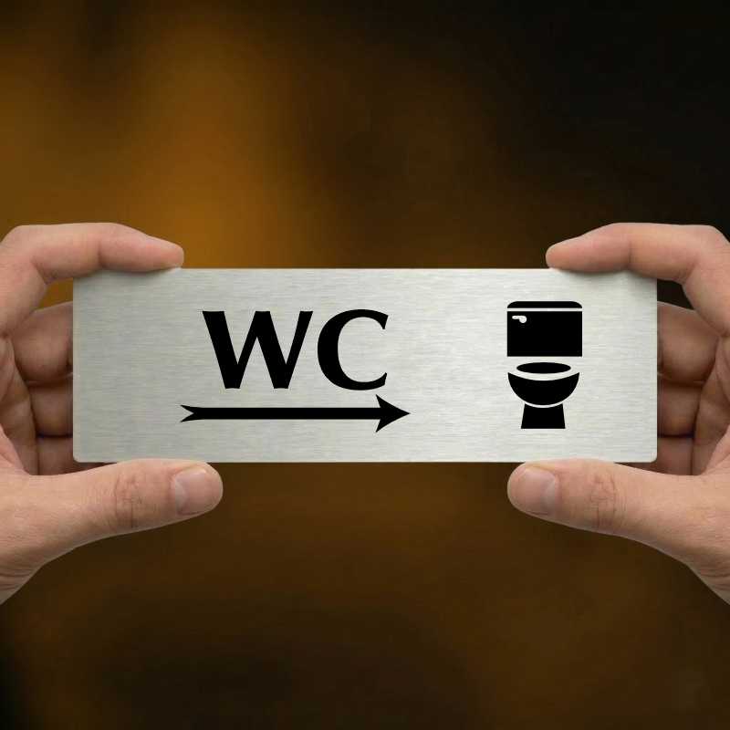 WC vpravo, 240x79mm, zlatá popiska s ozdobou uprostřed