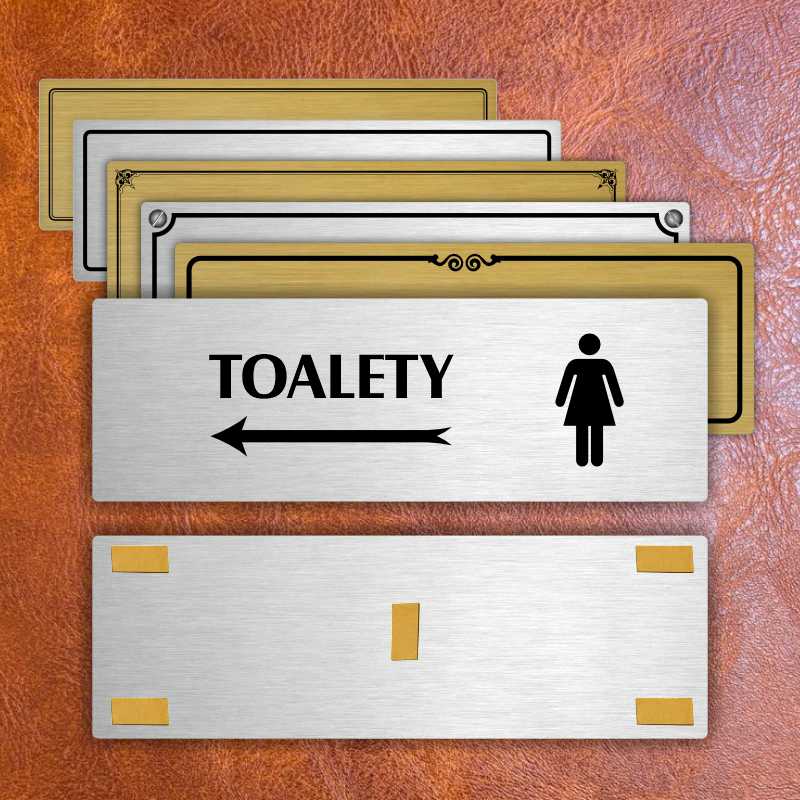 Toalety vlevo ženy, 200x66mm, zlatá popiska s dvojtým rámečkem