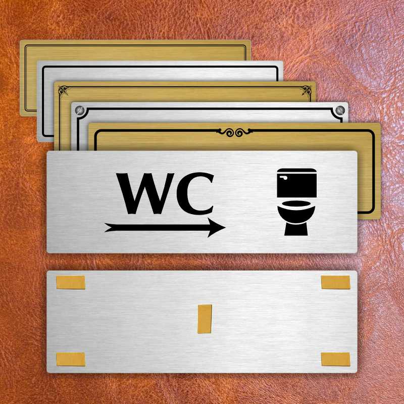 WC vpravo, 240x79mm, zlatá popiska s ozdobou uprostřed