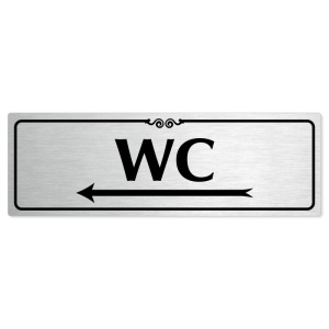 WC vlevo, 240x79mm, stříbrná popiska s ozdobou uprostřed